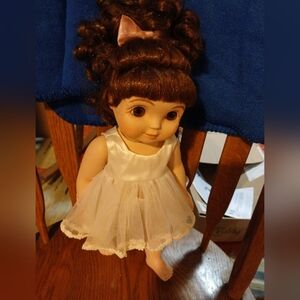 Charming Brown-Haired China Doll in White Dress